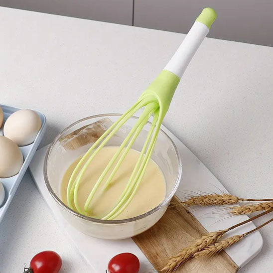 fouet-torsadé-vert-mélange-une-crème-sur-contoir-cuisine