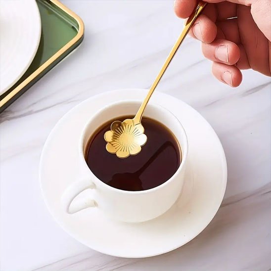 Homme tient cuillère forme maguerite au-dessus de tasse café blanche