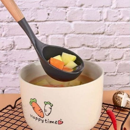 légumes  dans louche en silicone noir tenue au-dessus d'un bol de soupe
