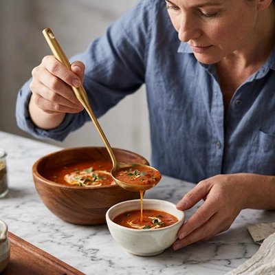 Louche femme rempli bol de soupe