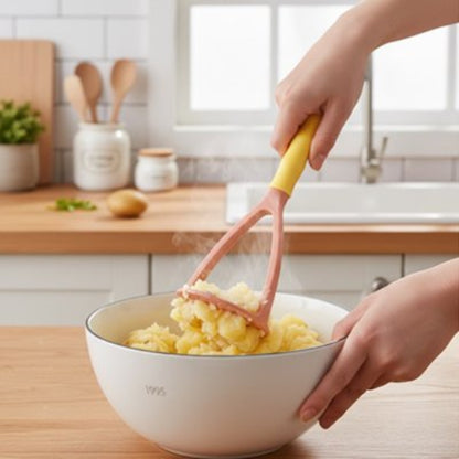 femme écrase pommes de terre dans grand bol blanc avec presse purée